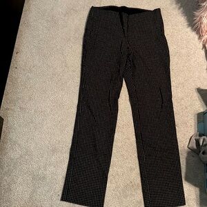 Blk pants white lines, down and cross. Slime 8 zip up on side.